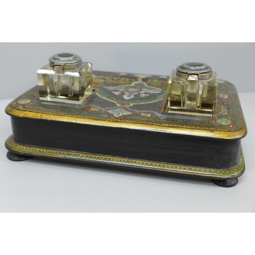 637 - A paper mache pen stand with a pair of ink bottles, painted and inlaid with mother of pearl, 27cm