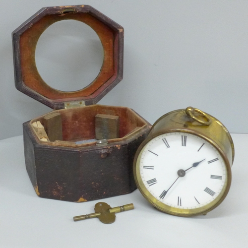 639 - A travel clock, Swiss movement with key, cased