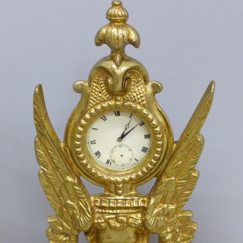 642 - A brass pocket watch stand with gold plated top-wind pocket watch