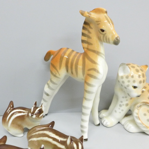 654 - A collection of nine USSR porcelain animal figures including giraffe calf, rabbits and zebra, one a/... 