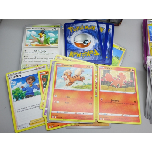 675 - Over 600 Pokemon cards including Holo, with two tins