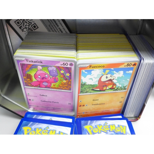 675 - Over 600 Pokemon cards including Holo, with two tins