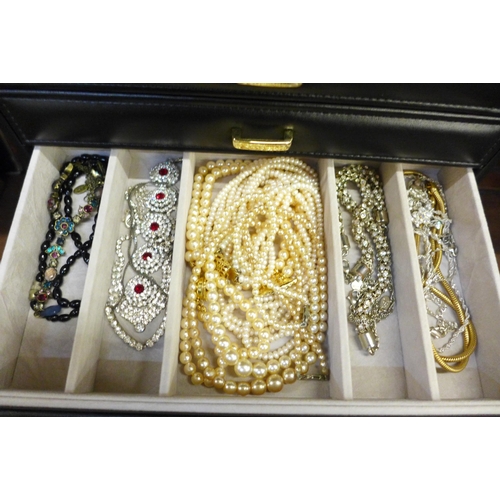 676 - A large jewellery box of modern costume jewellery