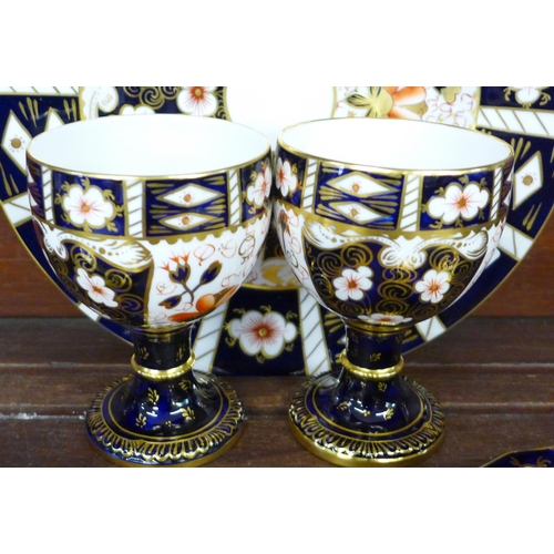 694 - A collection of Royal Crown Derby 2451 pattern china, a plate, two cups and saucers and two goblets