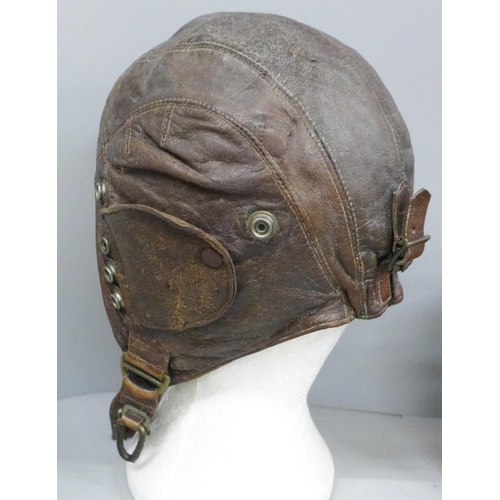 710 - A leather WWI flying hat, a pair of WWII binoculars and a leather gorget