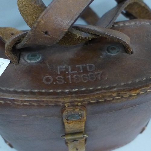 710 - A leather WWI flying hat, a pair of WWII binoculars and a leather gorget