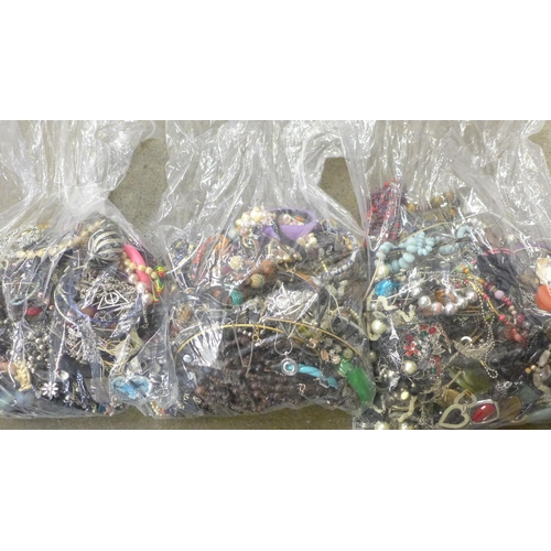 711 - Three large bags of costume jewellery