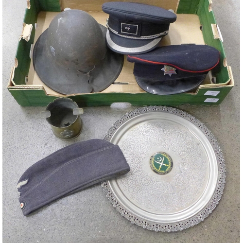 712 - A brass trench art ashtray, tray with Pakistan Army badge, two peaked caps, German Luftwaffe side ca... 