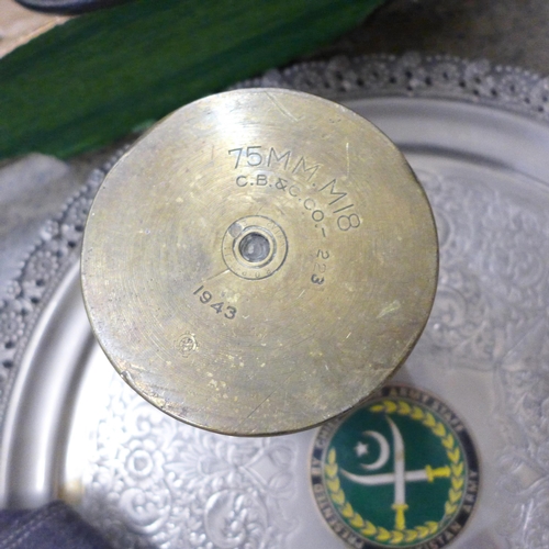 712 - A brass trench art ashtray, tray with Pakistan Army badge, two peaked caps, German Luftwaffe side ca... 