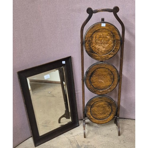 362 - An early 20th Century oak folding cake stand and oak framed mirror