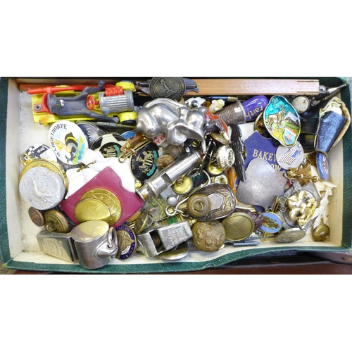 724 - A small case of assorted items including whistles, badges, advertising, etc.