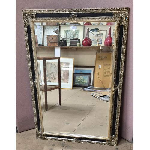 361 - A Victorian style ebonised and silver effect framed mirror