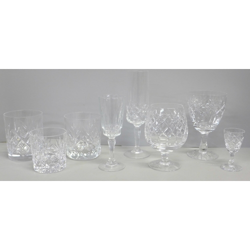 776 - A suite of crystal glassware including tumblers and wines of different sizes, decanters, jugs, bowl,... 