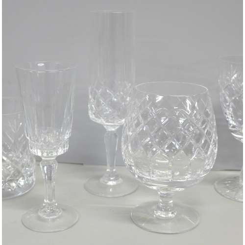 776 - A suite of crystal glassware including tumblers and wines of different sizes, decanters, jugs, bowl,... 