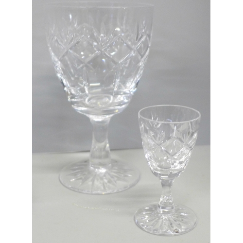 776 - A suite of crystal glassware including tumblers and wines of different sizes, decanters, jugs, bowl,... 