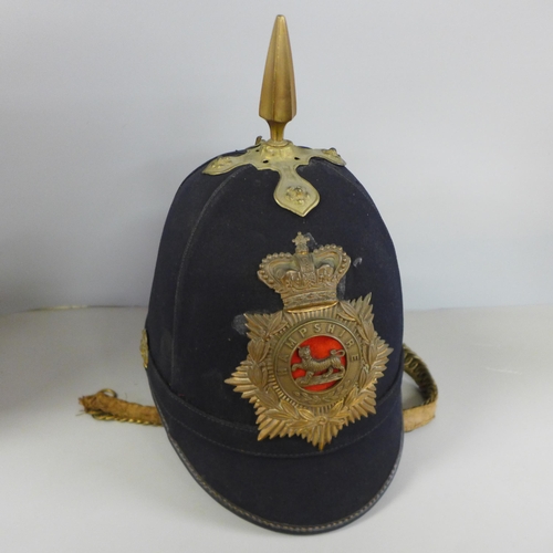 784 - A Hampshire regiment blue cloth helmet, issue mark 1911