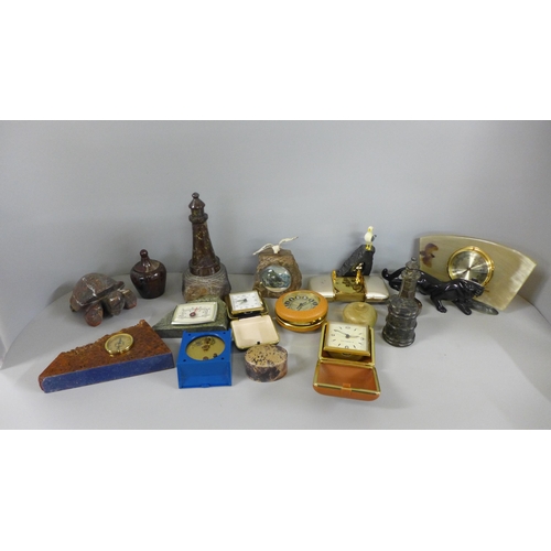 785 - A collection of carvings, alarm clocks including two serpentine lighthouses, etc.