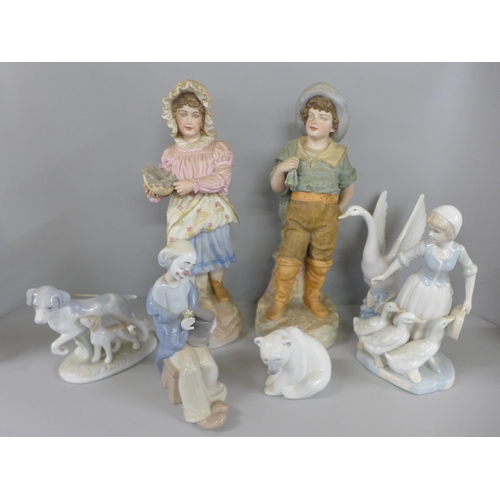 794 - A pair of continental bisque figures, Lladro Polar Bear, Nao clown, etc