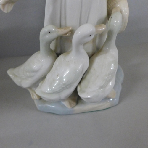 794 - A pair of continental bisque figures, Lladro Polar Bear, Nao clown, etc