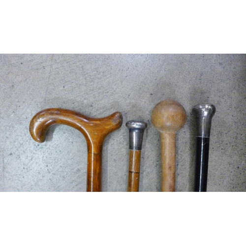 802 - Two silver topped walking canes and two others