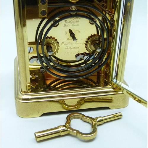 816 - A Matthew Norman gilt brass timepiece with striking movement, Swiss movement, with key