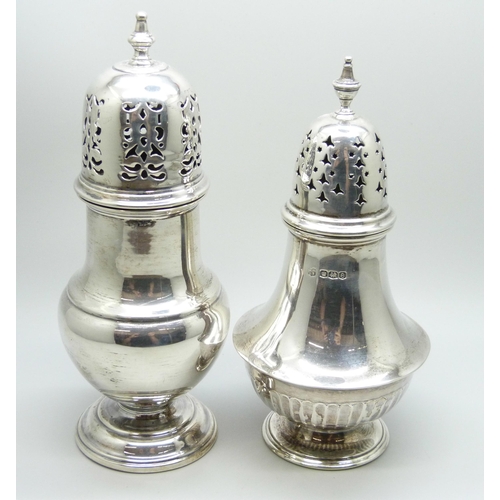 864 - A silver caster and a caster with continental control marks, 138g and 146g