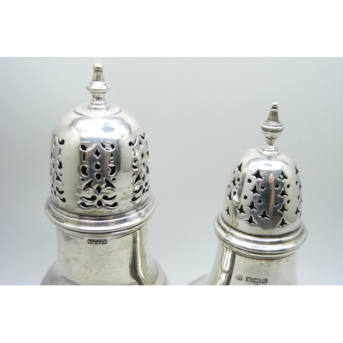 864 - A silver caster and a caster with continental control marks, 138g and 146g