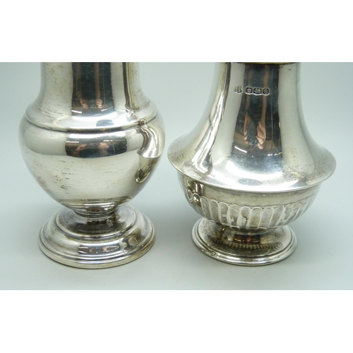 864 - A silver caster and a caster with continental control marks, 138g and 146g