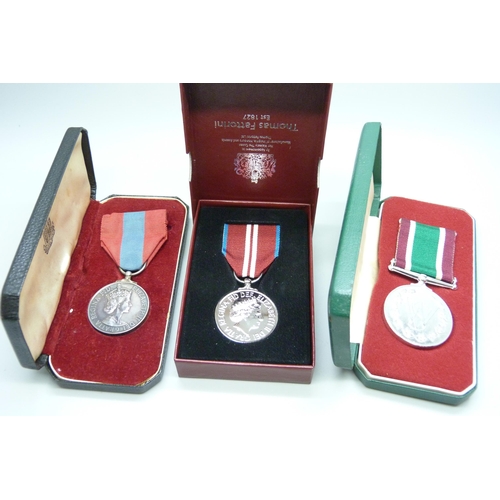 882 - Three medals, including a Queen Elizabeth II For Faithful Service medal to Harold Augustus Storr