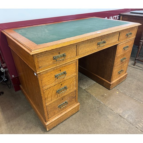 237 - A Victorian oak and green leather topped pedestal desk