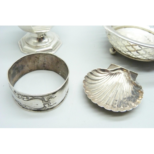 890 - A silver caster, Chester 1908, a pierced silver dish,  a silver napkin ring and a caddy spoon marked... 