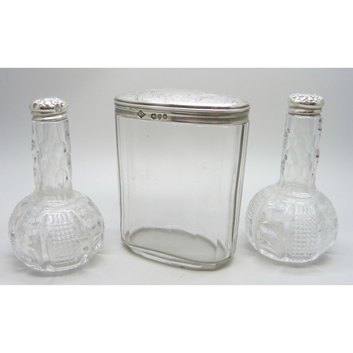 895 - A Victorian silver topped glass jar and two silver topped oil bottles