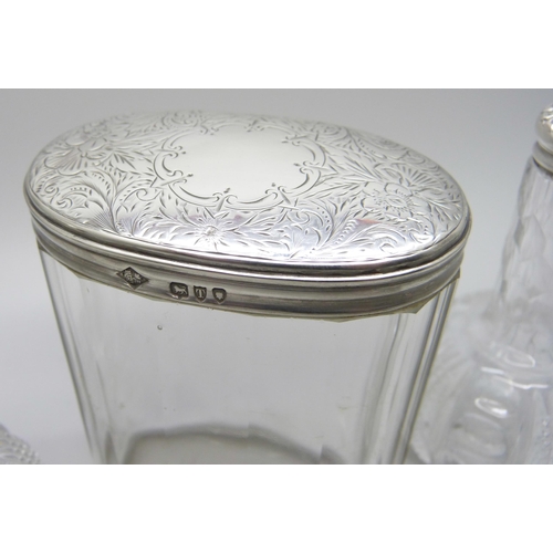 895 - A Victorian silver topped glass jar and two silver topped oil bottles