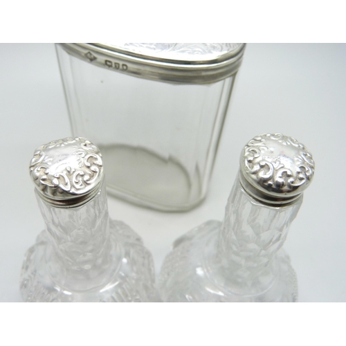 895 - A Victorian silver topped glass jar and two silver topped oil bottles