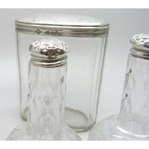 895 - A Victorian silver topped glass jar and two silver topped oil bottles