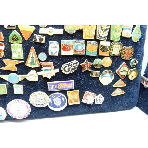 904 - A large collection of Eastern European badges and one boxed medallion