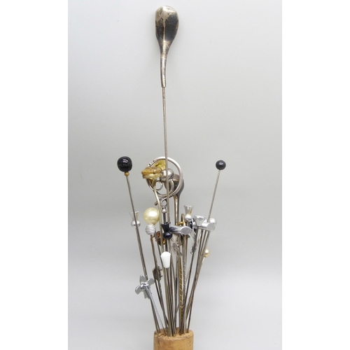 911 - A collection of hat pins, including two hallmarked silver in the form of golf clubs, one by Charles ... 