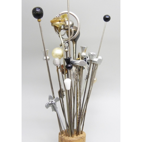 911 - A collection of hat pins, including two hallmarked silver in the form of golf clubs, one by Charles ... 