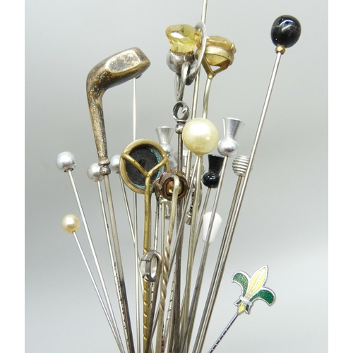 911 - A collection of hat pins, including two hallmarked silver in the form of golf clubs, one by Charles ... 