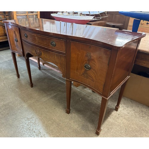 243 - A Regency style inlaid mahogany serpentine sideboard