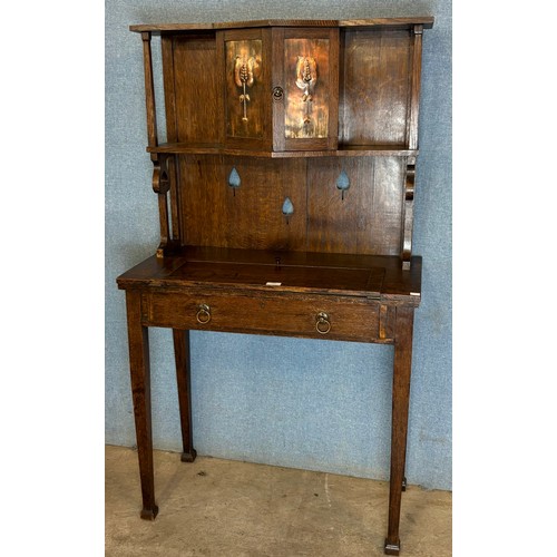 126 - An Arts and Crafts Liberty & Co. style oak bonheur de jour