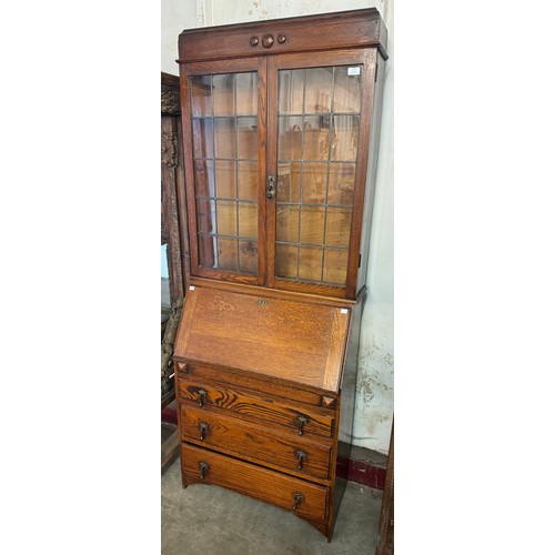 247 - An early 20th Century carved oak bureau bookcase