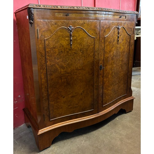 130 - A Queen Anne style fitted burr walnut serpentine cocktail cabinet