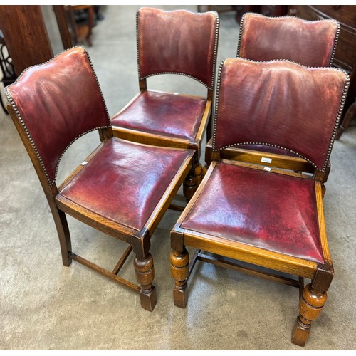 183 - A set of four early 20th Century oak and red leather dining chairs