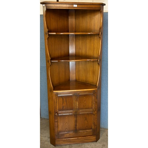 143 - An Ercol Golden Dawn elm freestanding corner cabinet