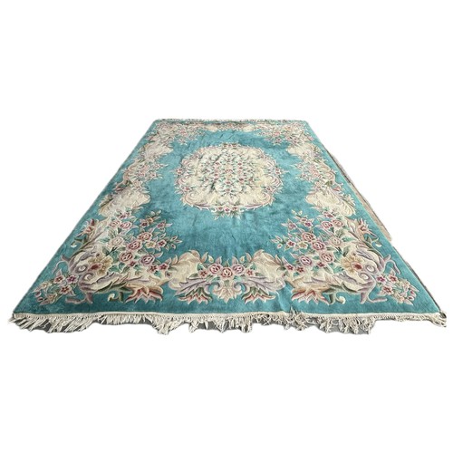 250 - A large Chinese turquoise ground rug 391x277cm