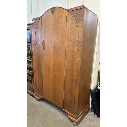 252 - An Art Deco carved oak wardrobe