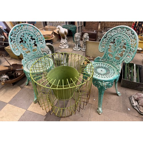 275 - Two cast iron garden chairs and painted metal plant stand