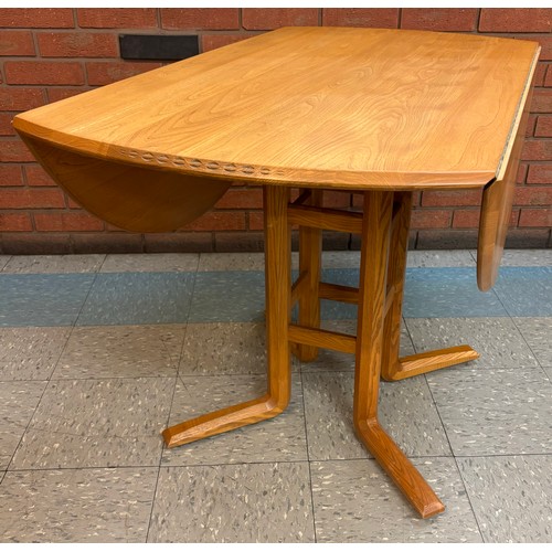 23G - An Ercol Blonde elm drop leaf dining table