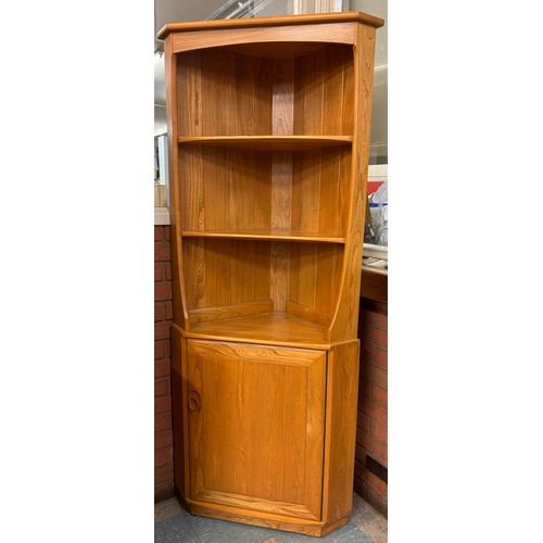 23H - An Ercol Blonde elm freestanding corner cabinet